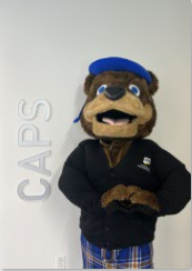 Picture of Scotty Highlander next to CAPS sign